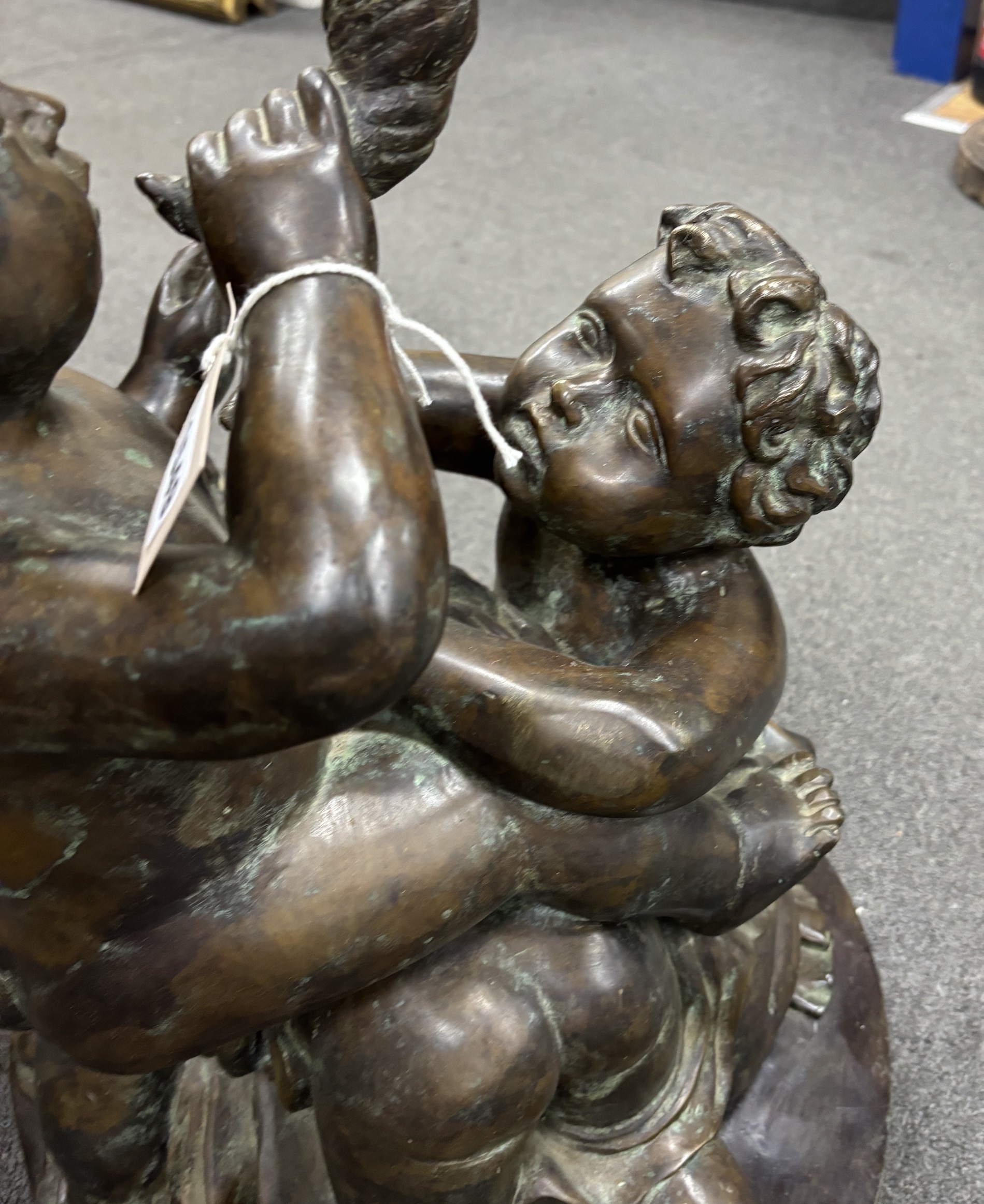 An early 20th century large bronze cherubic figure group, 52cm